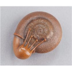 A wood netsuke of a snail.