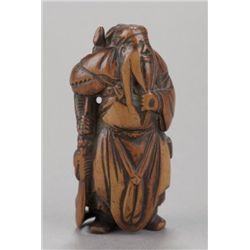 A wood netsuke of Kwan-Yu.