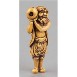 An ivory netsuke of a foreigner carring Tama.