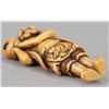Image 7 : An ivory netsuke of a foreigner carring Tama.