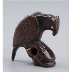 A wood netsuke of a falcon.