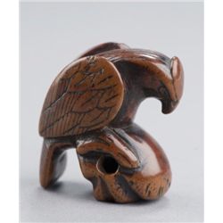 A wood netsuke of falcon.