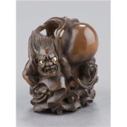 A wood netsuke of Futen.
