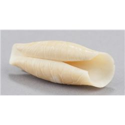 An ivory netsuke of curled lotus leaf.