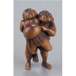 A wood netsuke of sumo wrestlers.
