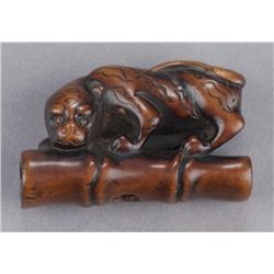 A boxwood netsuke of tiger on bamboo.