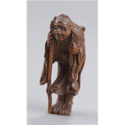 A wood netsuke of Sennin.