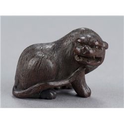 A wood netsuke of tiger.