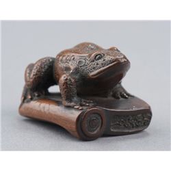 A wood netsuke of toad.