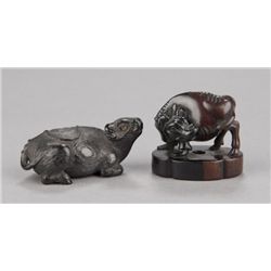 A group of two wood netsuke of bulls.