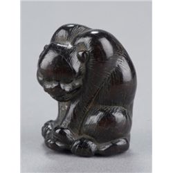 A wood netsuke of a tiger.