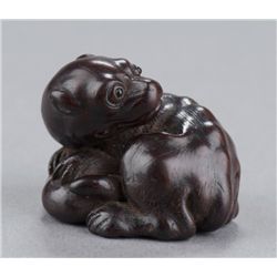 A wood netsuke of an animal.