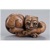 Image 2 : A group of three netsuke of tigers.