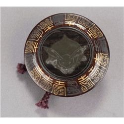 A wood, pewter, and lacquer manju with design of a