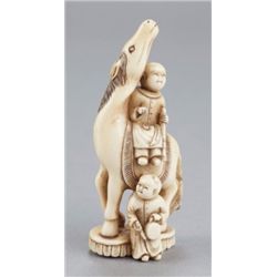 An ivory netsuke of a horse and two karako.