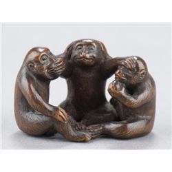 A wood netsuke of monkey triad.