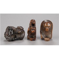 Group of three wood netsuke of monkeys.