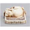 Image 6 : An ivory netsuke of dog seated in front of tsuitat