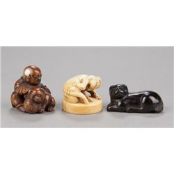A group of three netsuke of dogs, various material