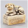 Image 7 : A group of three ivory netsuke of dogs.