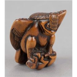 A wood netsuke of an eagle.