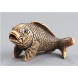 An ivory netsuke of a carp.