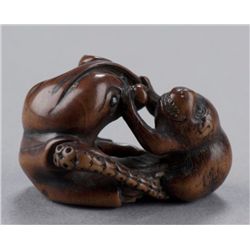 A wood netsuke of an octopus and monkey.