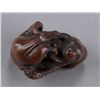 Image 7 : A wood netsuke of an octopus and monkey.