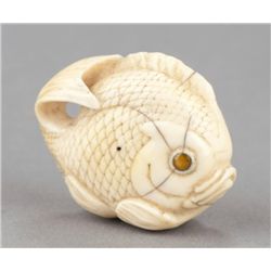 An ivory netsuke of a sea bream.
