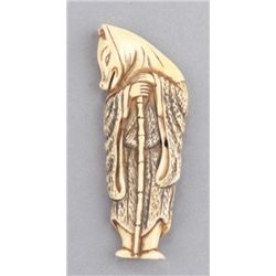 An ivory netsuke of a fox priest.