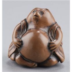 A wood netsuke of Tanuki.
