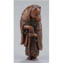 A wood netsuke of a fox priest.