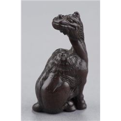 A cherry wood netsuke of a kirin.