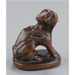 A wood netsuke of a kirin.