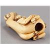 Image 5 : An ivory netsuke of a siniu and monkey.