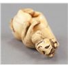 Image 6 : An ivory netsuke of a siniu and monkey.
