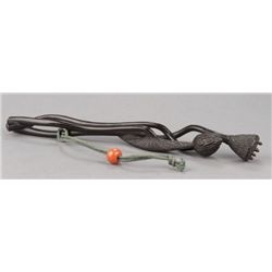 A wood sashi netsuke of a Lotus.