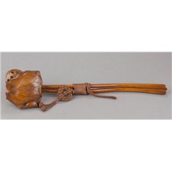 A black wood sashi netsuke of a Lotus.