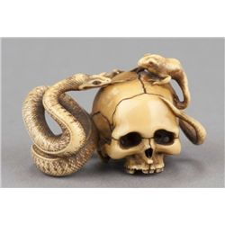 A marine ivory netsuke of San Sukumi.