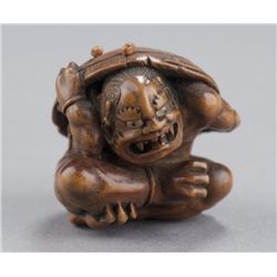 A wood netsuke of an oni.