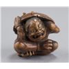 Image 1 : A wood netsuke of an oni.