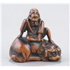 Image 2 : A wood netsuke of a Sennin on a shishi.