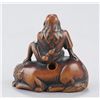 Image 4 : A wood netsuke of a Sennin on a shishi.