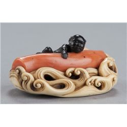 An ivory and ebony netuske of a kurumbo diver.