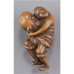 A wood netsuke of an octopus and awabi diver.