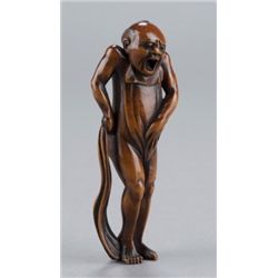 A wood netsuke of a nude man.