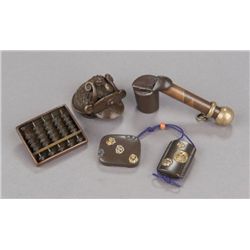 A group of four metal netsuke.