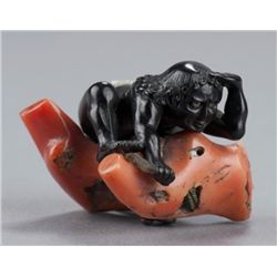 An ebony and coral netsuke of a Karumbo diver.