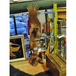 Wood carved eagle feeding her young