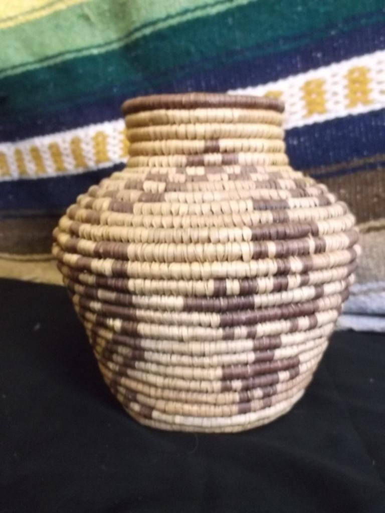 Handmade Indigenous Basket 7 ½” x 7 ½‘” A small olla shaped basket, with animal and human figures. A